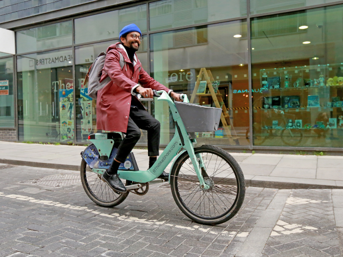 "A man riding a bike on a road"