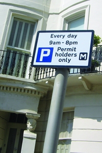 A sign showing the parking restrictions for a permit bay