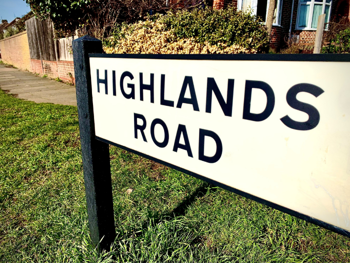 "A road sign with the words 'Highlands Road'"