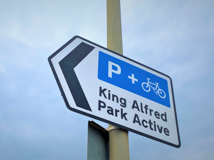 "a picture of a road sign with the words King Alfred, Park Active"