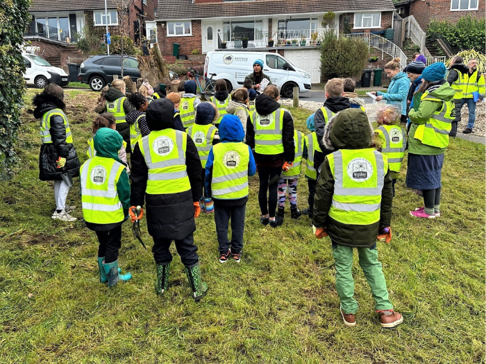 School children listening to an adult talking