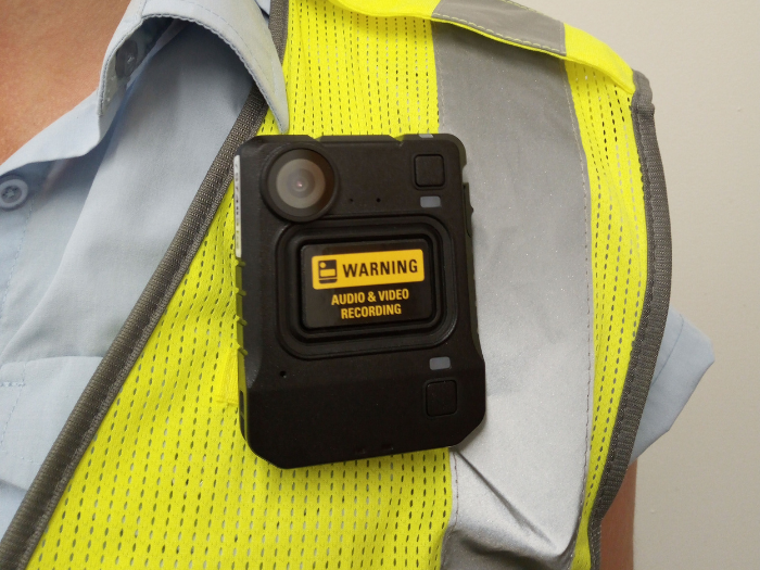 A person in a hi-viz jacket wearing a camera