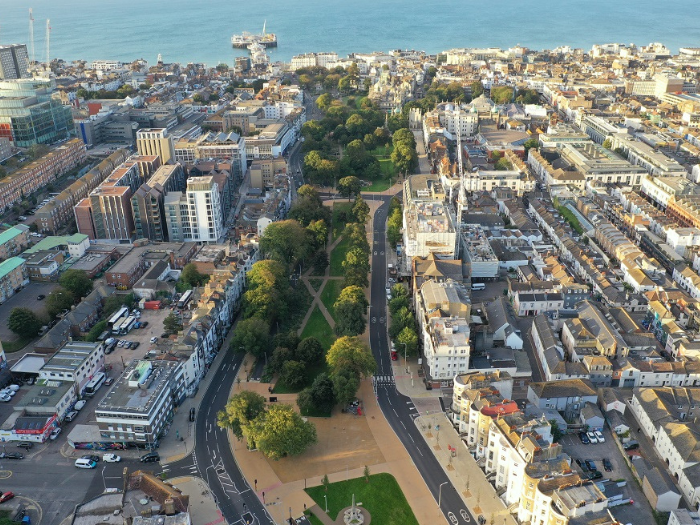 an aerial view of roads, buildings and green spaces