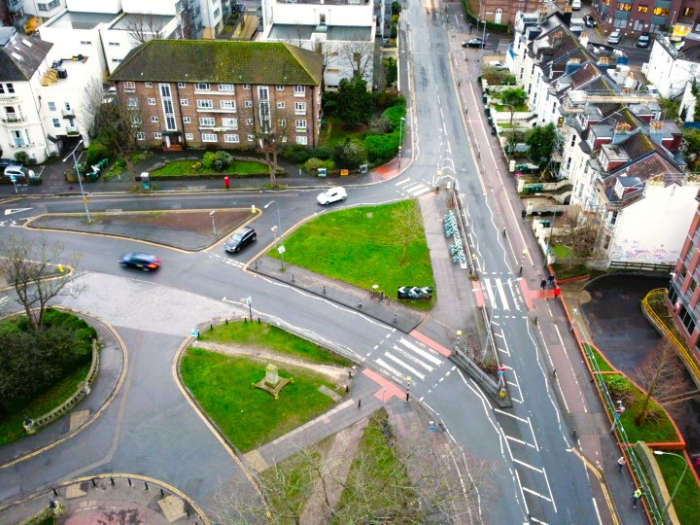 A picture of a road junction with a zebra crossing and cars