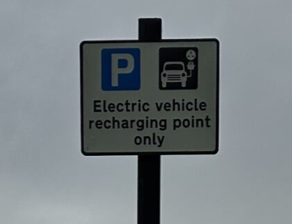 EV only charging bay sign. Blue P and electric charging symbol.