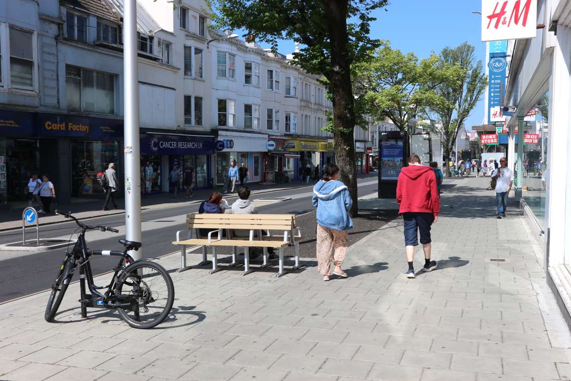 Western Road after the improvement works, including new road and pavement surfaces, seating and cycle parking.