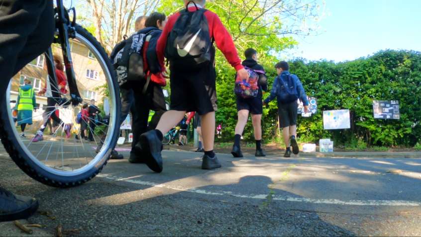 People riding and walking to school.