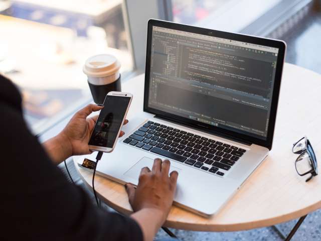 Business person with laptop on desk