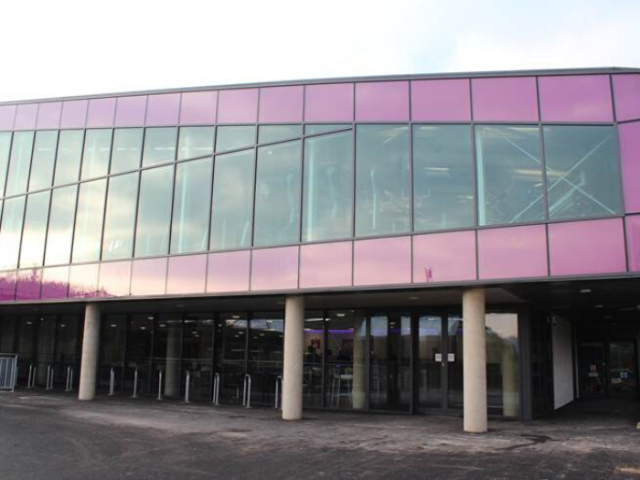 Exterior of Wihtdean Sports Complex, showing purple and glass frontage