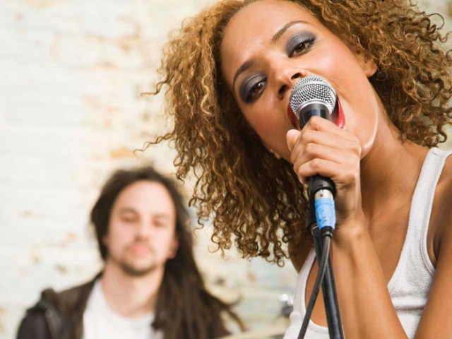 Two band members, foreground female singer