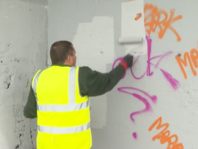 Picture of graffiti being removed by council employee