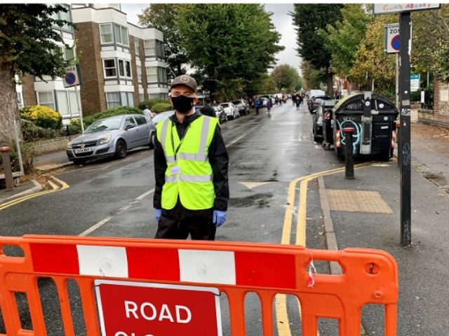 Volunteer supporting a road closure