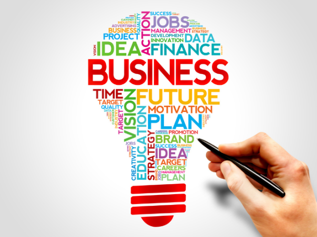 Lightbulb illustration with business-friendly words such as 'finance, ideas and future' and a hand holding a pen