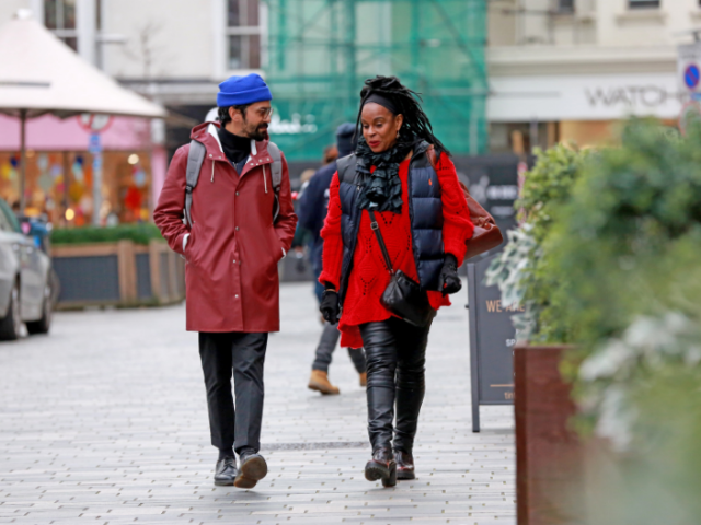 Two people walking down a pedestrianised street