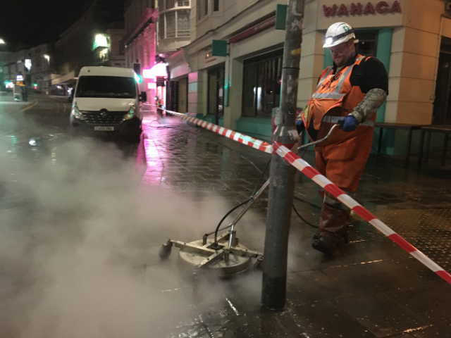 Cityclean staff cleaning pavements int he city centre.