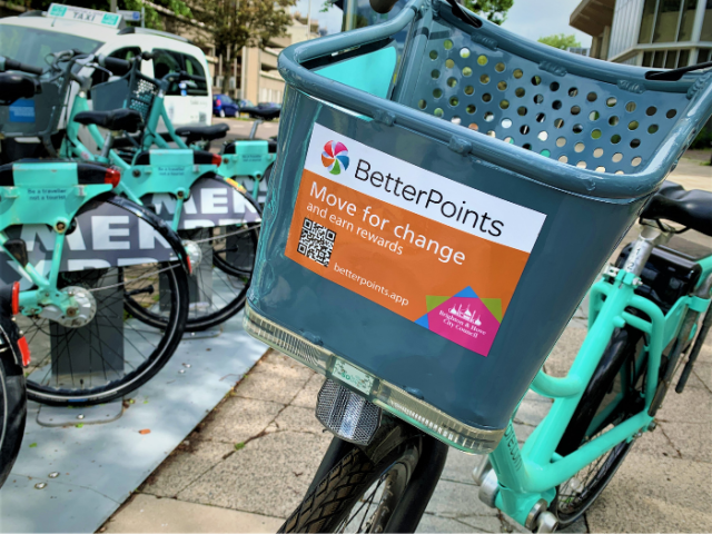 A picture of a bicycle with a sticker on the front of the basket reading 'BetterPoints'