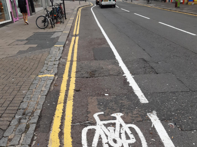 A road with a painted cycle lane and a painted picture of a bicycle