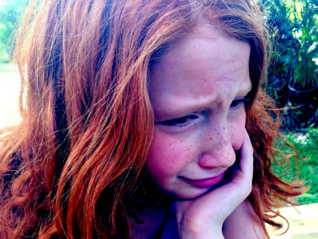 A child looking upset.