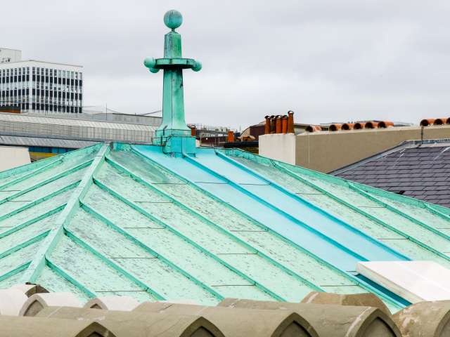 The pyramid-shaped copper roof of the Studio Theatre. The copper has aged to a mint green colour.