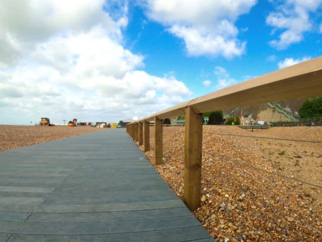 Photograph looking along the beach boardwalk near Madeira Drive in Brighton