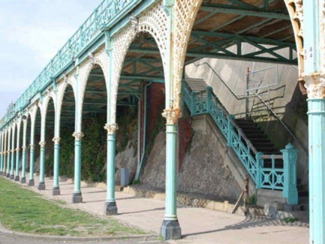 Madeira Terrace arches stretch away into the distance with white spandrels supported by light blue columns supporting each bay