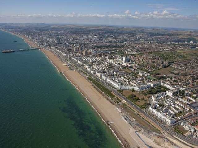 Image of an aerial shot of the sea with Brighton in the background  