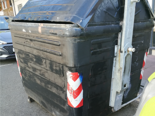 Photograph of graffiti free large black bin.