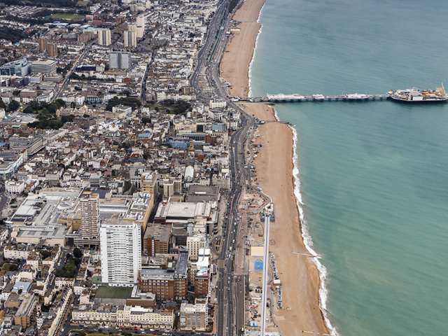 An aerial view of Brighton seafront looking east. Looking over the Pier, Marina and the white cliffs of Saltdean in the distance