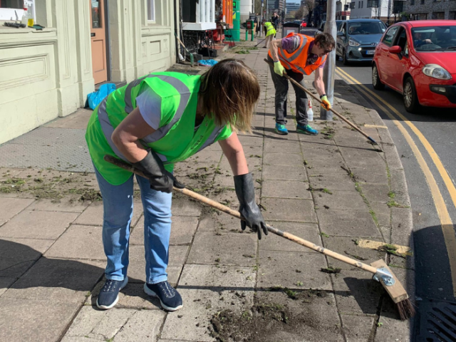 Photos of volunteers helping to clear a pavement in Brighton & Hove 