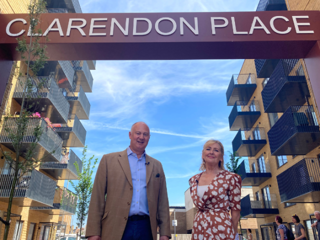 Guy Slocome, Hyde's Chief Investment Officer, and Councillor Gill Williams, chair of the Housing & New Homes Committee, standing under the Clarendon Place feature arch at the Homes for Brighton & Hove development opening event 