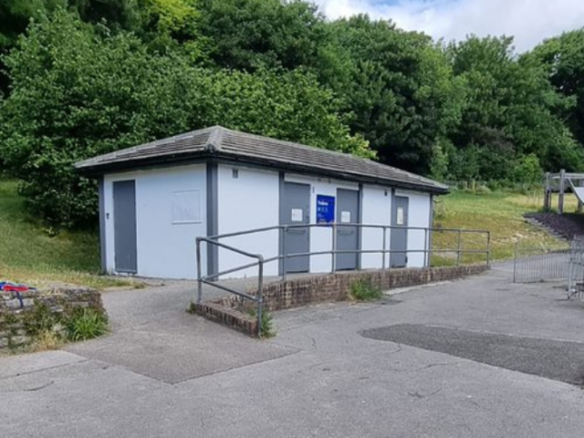 Photograph of a public toilet block in a park.