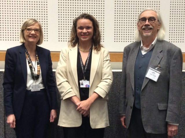 From left to right, Cllr Liz Loughran, Council Leader Bella Sankey and Planning Agents' Forum Chair Nick Lomax stand in a group facing the camera with the wall of the council chamber behind them