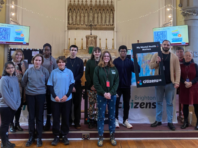 Councillor Andrei Czolak standing in a group shot with pupils from Cardinal Newman School and members of Brighton & Hove Citizens group