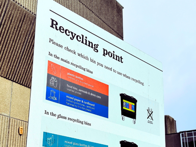 A picture of a recycling point sign