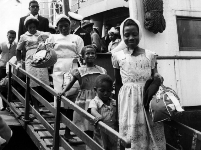 A group of people standing on the steps of the Empire WIndrush