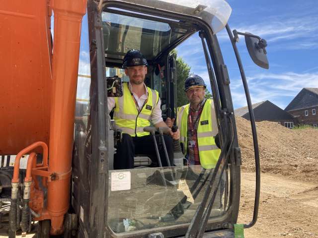 Councillors Tristram Burden and Paul Nann in a digger on the Brickfields site