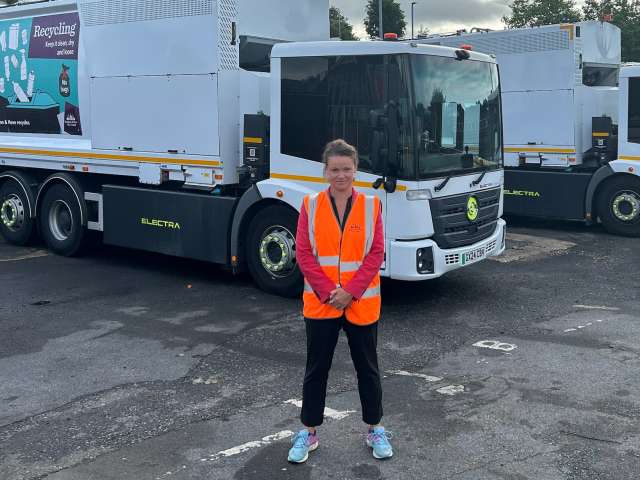 Councillor Bella Sankey standing in front of a waste collection lorry at the depot.