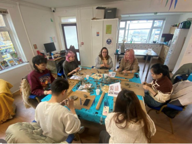 A group of young people sat around a table at the Youth Employment Hub