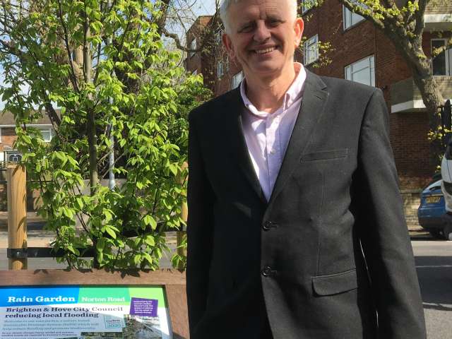 Councillor Trevor Muten with the Norton Road rain garden tree and sign