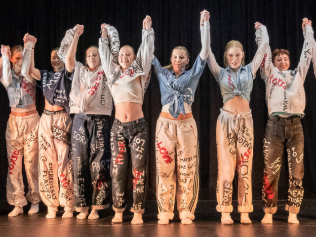 A group of young people stood on a stage