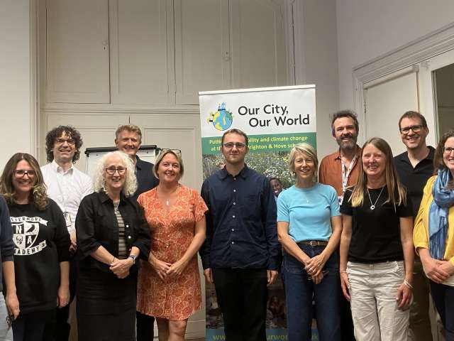 Teachers and education leaders on the Our Schools, Our World project, in front of the OSOW banner in Brighton Town Hall.