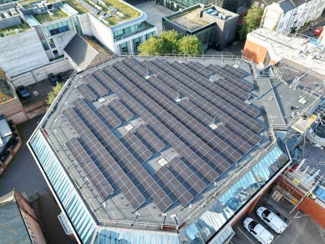 Aerial view of solar panels on the roof of the Prince Regent Swimming Complex