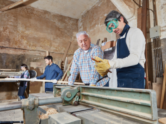 A group of people working in a woodworking shop