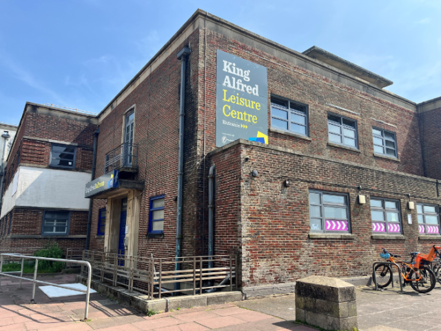 Photo of the north west corner of the King Alfred Leisure Centre. it's a brick building that looks run-down. 