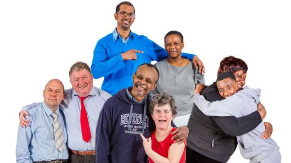 Four couples smiling and hugging.