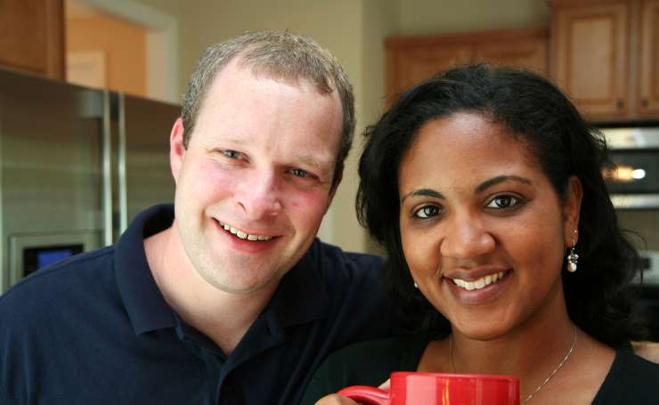 2 adults smiling in a kitchen