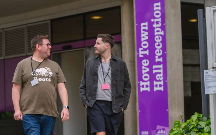 2 Brighton & Hove City Council workers walking past the outside of Hove Town Hall reception wearing casual clothes