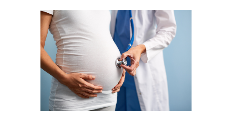 Stethoscope on pregnant woman's stomach.