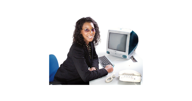 Woman sat at desk in front of computer.