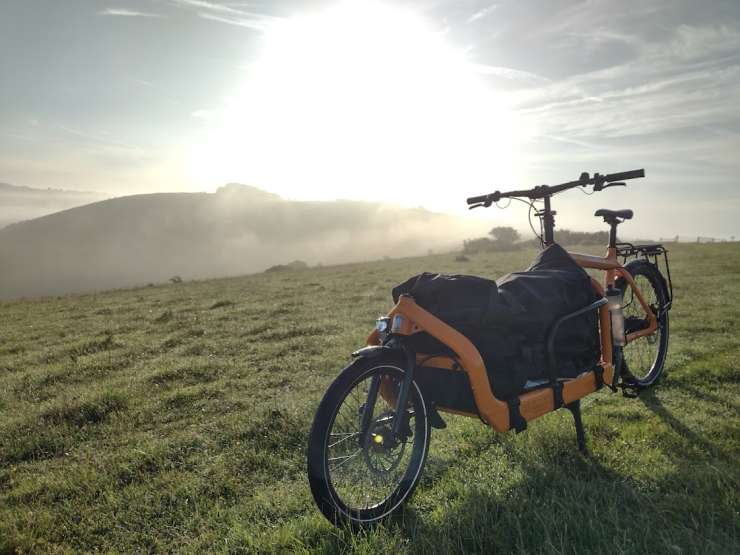 Photograph of an eCargo bike on a hill on a sunny day